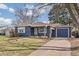Charming blue single-story home featuring a well-maintained lawn and inviting curb appeal at 2718 S Hazel Ct, Denver, CO 80236