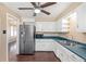 This kitchen features white cabinets, stainless appliances, and plenty of counter space at 2718 S Hazel Ct, Denver, CO 80236