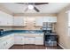 Kitchen view featuring white cabinets, laminate countertops and stainless steel range at 2718 S Hazel Ct, Denver, CO 80236