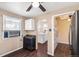 Galley kitchen featuring appliances, laminate countertop, and a view into the laundry room and living room at 2718 S Hazel Ct, Denver, CO 80236