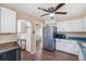 A wide shot of the kitchen with stainless steel refrigerator, microwave and range at 2718 S Hazel Ct, Denver, CO 80236