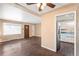 Open living room with hardwood floors, a kitchen view, and a ceiling fan at 2718 S Hazel Ct, Denver, CO 80236