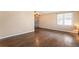 Spacious living room with hardwood floors, neutral paint, and lots of natural light at 2718 S Hazel Ct, Denver, CO 80236