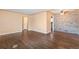 Spacious living room featuring hardwood floors, neutral paint, and a decorative stone accent wall at 2718 S Hazel Ct, Denver, CO 80236