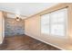 Bright living room featuring a fan, hardwood floors, neutral walls, and large windows at 2718 S Hazel Ct, Denver, CO 80236