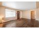 A spacious living room with wood floors and a large window providing natural light at 2718 S Hazel Ct, Denver, CO 80236