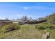 Spacious backyard enclosed by a wooden fence with hillside potential for outdoor activities at 4507 W 2Nd Ave, Denver, CO 80219