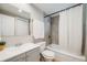 Clean bathroom featuring a shower-tub combo and modern gray vanity at 4507 W 2Nd Ave, Denver, CO 80219