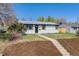 Front yard view of a charming single story home with inviting entryway and well-manicured lawn at 4507 W 2Nd Ave, Denver, CO 80219