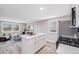 Bright open concept kitchen and living area featuring a kitchen island with white countertops and stainless steel appliances at 4507 W 2Nd Ave, Denver, CO 80219