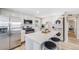 Modern kitchen featuring stainless steel appliances, a bright island, and convenient in-unit laundry at 4507 W 2Nd Ave, Denver, CO 80219