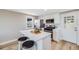 Modern, updated kitchen featuring stainless steel appliances, white cabinets, and an island with seating at 4507 W 2Nd Ave, Denver, CO 80219
