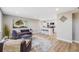 Sunlit living room featuring hardwood floors and comfortable seating, with an open view of the modern kitchen at 4507 W 2Nd Ave, Denver, CO 80219