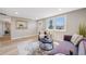 Comfortable living room with neutral walls and hardwood floors, offering natural light and a view of the front entrance at 4507 W 2Nd Ave, Denver, CO 80219