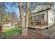 Backyard showcasing the home, a seating area, a modern hot tub, and some landscaping at 11885 W Katherine Ave, Lakewood, CO 80401