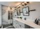 Bright bathroom featuring a dual sink vanity, modern fixtures, and a luxurious glass-enclosed shower at 11885 W Katherine Ave, Lakewood, CO 80401