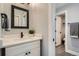 Charming bathroom showcasing a vanity with a decorative mirror and modern fixtures at 11885 W Katherine Ave, Lakewood, CO 80401
