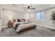 Spacious bedroom with a platform bed, a soft carpet, and a bright window at 11885 W Katherine Ave, Lakewood, CO 80401