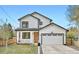 Charming two-story home with white siding, black trim, covered porch, and attached two-car garage at 11885 W Katherine Ave, Lakewood, CO 80401