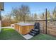 Backyard with a wooden hot tub, a well-manicured lawn, and a private fenced-in area at 11885 W Katherine Ave, Lakewood, CO 80401