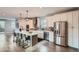 Modern kitchen with stainless steel appliances, white cabinets, ample counter space, and a large center island at 11885 W Katherine Ave, Lakewood, CO 80401