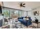 Cozy living room with stylish decor, large windows, fireplace, and access to a deck for outdoor relaxation at 11885 W Katherine Ave, Lakewood, CO 80401