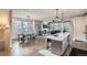 Open living space featuring a dining area, kitchen island with seating, fireplace, and access to the outdoor living at 11885 W Katherine Ave, Lakewood, CO 80401