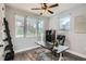 Bright home office featuring multiple windows, stylish rug, and a comfortable workspace at 11885 W Katherine Ave, Lakewood, CO 80401