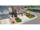 Aerial view of a well-maintained home featuring a three-car garage and landscaping at 15100 Gaylord St, Thornton, CO 80602