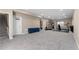 Spacious basement with carpet flooring, gym equipment, and a basketball hoop for recreational activities at 15100 Gaylord St, Thornton, CO 80602