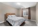 Bedroom with a queen-sized bed, window, and neutral walls, creating a peaceful retreat at 15100 Gaylord St, Thornton, CO 80602
