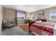 Cozy bedroom with large window, telescope, and armchair; provides comfortable space for relaxation at 15100 Gaylord St, Thornton, CO 80602