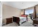 Bedroom with a desk, window, and comfortable bed, perfect for relaxation and study at 15100 Gaylord St, Thornton, CO 80602