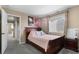 Cozy bedroom features neutral walls, a window, and a comfortable bed with a floral pillow at 15100 Gaylord St, Thornton, CO 80602