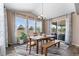 Bright dining room features stylish chandelier, abundant natural light, and sliding glass doors to covered outdoor space at 15100 Gaylord St, Thornton, CO 80602