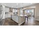 Modern kitchen with stainless steel appliances, an island with a breakfast bar, and ample cabinet space at 15100 Gaylord St, Thornton, CO 80602
