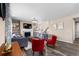 Bright living room with a fireplace, hardwood floors, and comfortable seating arrangements at 15100 Gaylord St, Thornton, CO 80602