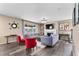 Well-lit living room with hardwood floors, a fireplace, and stylish furnishings at 15100 Gaylord St, Thornton, CO 80602