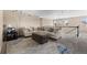 Carpeted loft features sectional sofa, ottoman, and modern lighting; perfect for relaxation or entertainment at 15100 Gaylord St, Thornton, CO 80602
