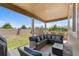 Cozy covered patio featuring stylish outdoor furniture and a view of the green lawn at 15100 Gaylord St, Thornton, CO 80602