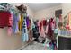 Organized walk-in closet with ample hanging space and storage baskets for a clutter-free wardrobe at 15100 Gaylord St, Thornton, CO 80602