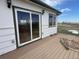 Charming home exterior featuring sliding glass doors leading to a wood deck and siding at 15200 Holly St, Thornton, CO 80602