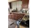 Outdated kitchen needing an upgrade, featuring dark cabinets and appliances at 15200 Holly St, Thornton, CO 80602