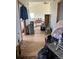 A cluttered interior living room needing renovation with a dining area visible in the background at 15200 Holly St, Thornton, CO 80602