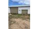 Outbuilding with two garage doors and a white door in the center at 15200 Holly St, Thornton, CO 80602