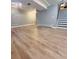 Spacious finished basement with wood-look flooring and staircase to upper level at 6973 Summerset Ave, Longmont, CO 80504