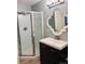 Updated bathroom with a glass shower, vanity, modern lighting and stylish mirror at 6973 Summerset Ave, Longmont, CO 80504