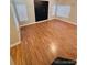 Spacious bedroom with wood floors and three large windows for ample natural light at 6973 Summerset Ave, Longmont, CO 80504
