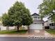 Charming two-story home with a well-manicured lawn and mature shade tree at 6973 Summerset Ave, Longmont, CO 80504