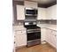 Well-lit kitchen features stainless steel appliances and white cabinetry at 6973 Summerset Ave, Longmont, CO 80504